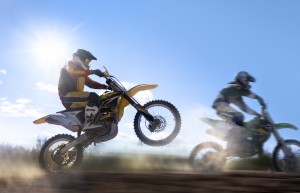 Motocross rider pulling a wheelie